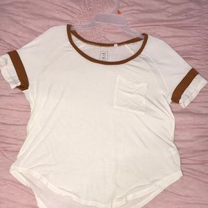 a beige t-shirt with burnt orange accents